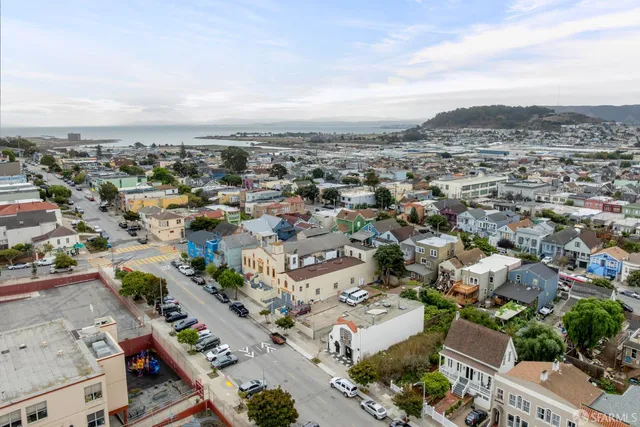 an aerial view of residential building with green space