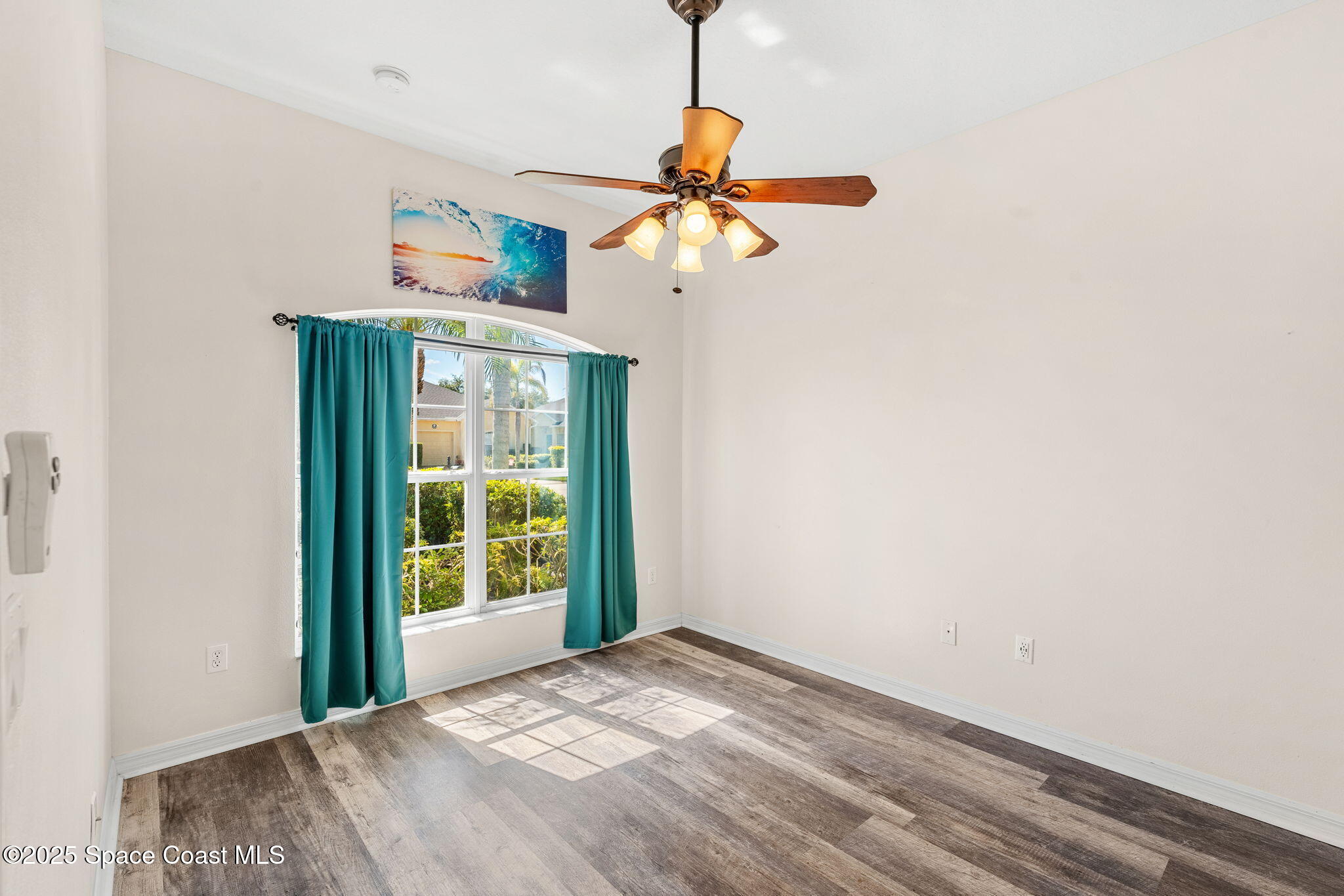 3130 Le Conte Street Melbourne, FL 32940 - Photo 13 of 35 a view of a bedroom with a ceiling fan and a window