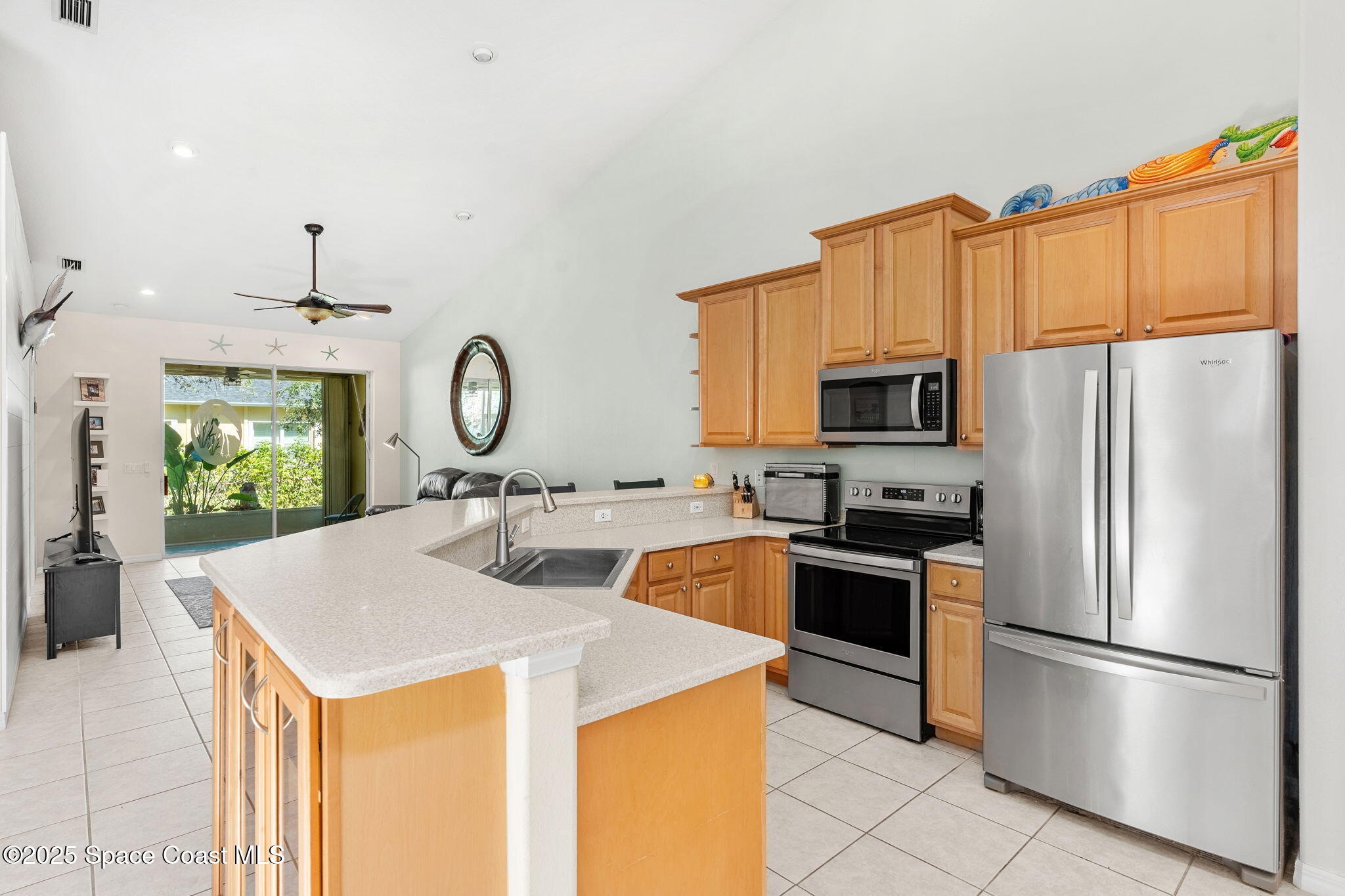 3130 Le Conte Street Melbourne, FL 32940 - Photo 5 of 35 a kitchen with stainless steel appliances granite countertop a refrigerator a stove a sink a microwave and a refrigerator