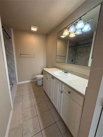 a bathroom with a sink a toilet and mirror