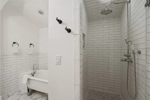 a bathroom with a sink a window and shower