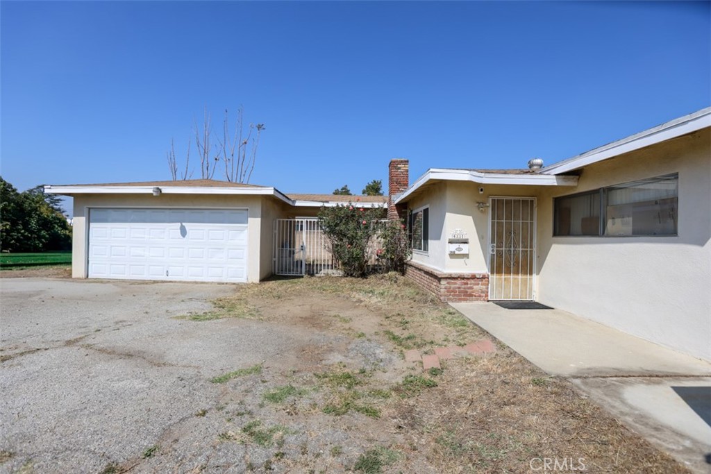 a front view of a house with a large window and garage