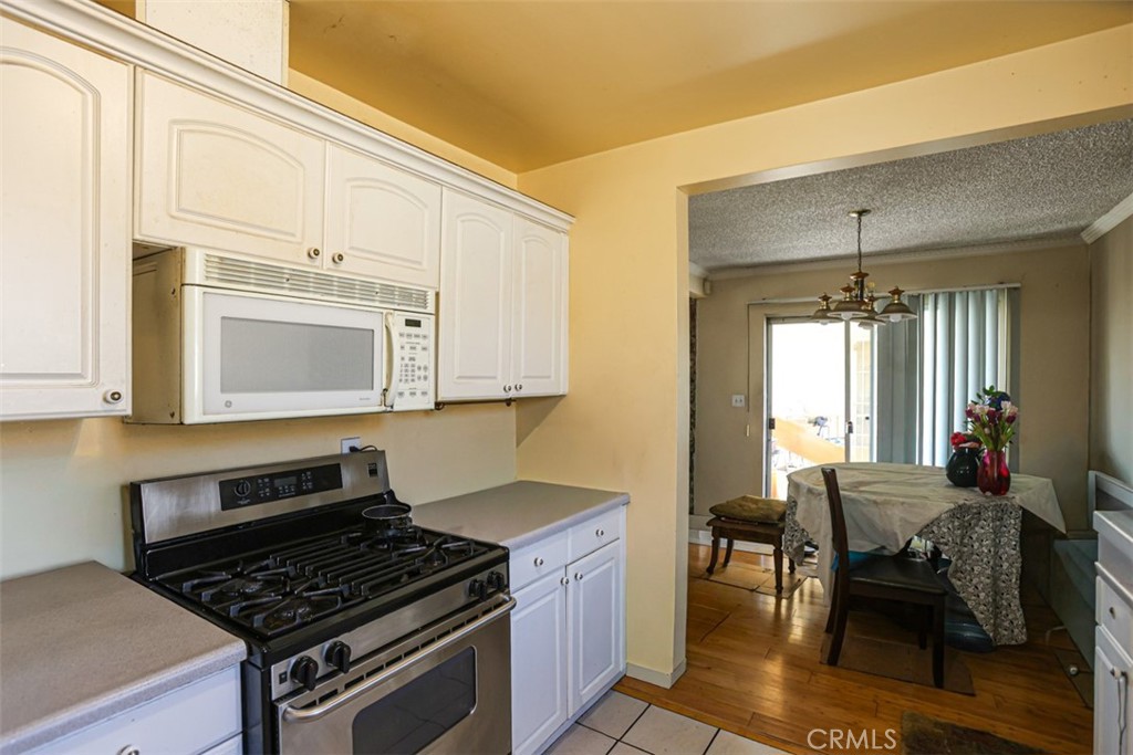 4331 Maxson Road El Monte, CA 91732 - Photo 12 of 32 a kitchen with stainless steel appliances a stove a sink cabinets and a dining table