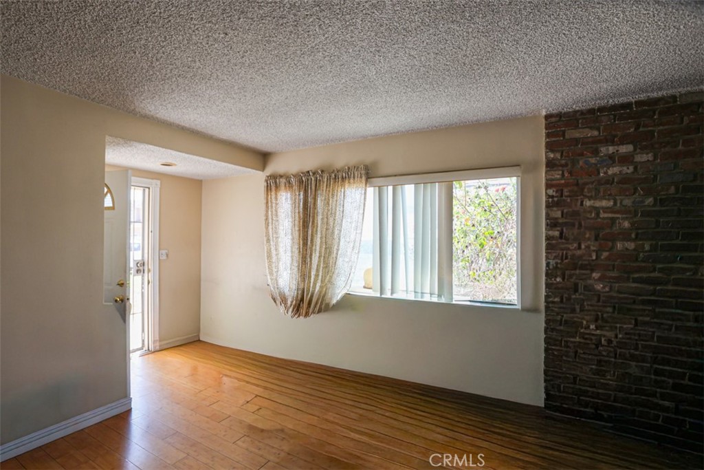 4331 Maxson Road El Monte, CA 91732 - Photo 5 of 32 a view of an empty room with wooden floor and a window