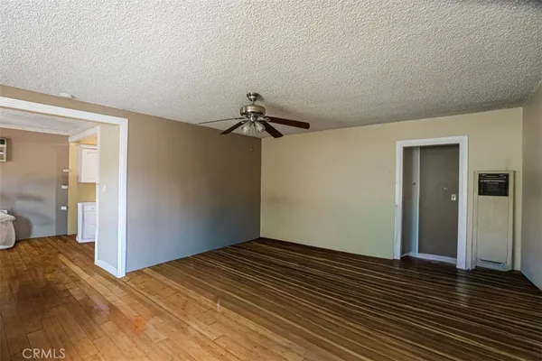 a view of a room with wooden floor