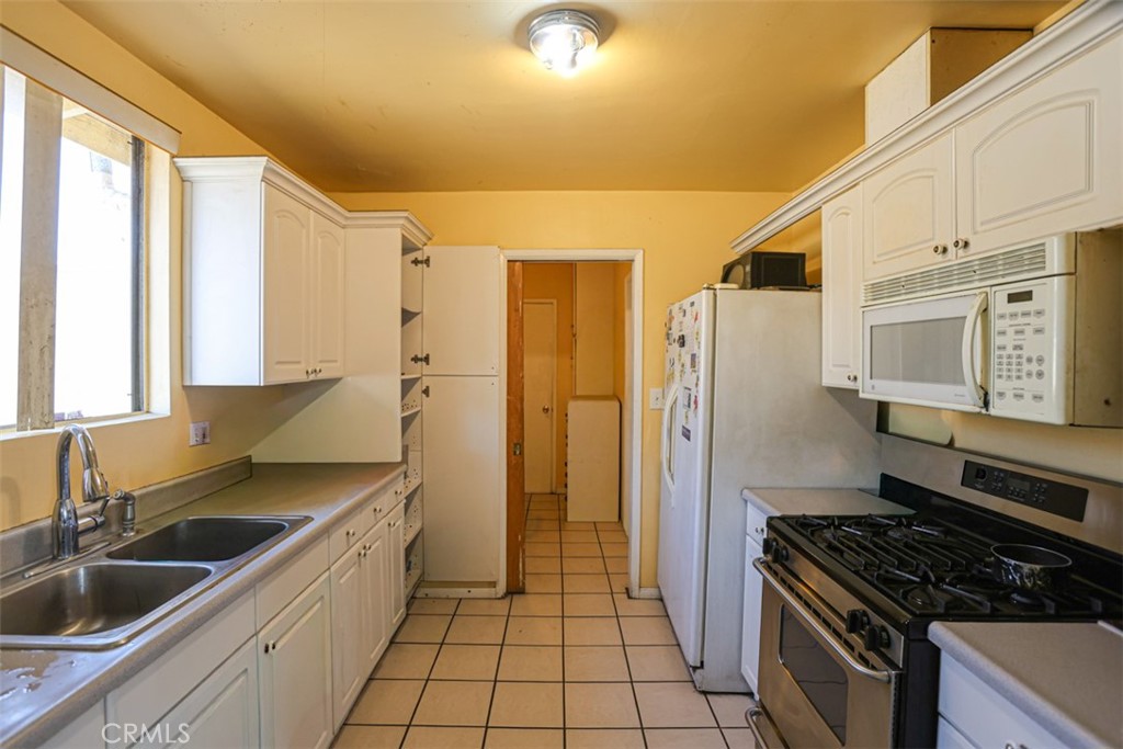 4331 Maxson Road El Monte, CA 91732 - Photo 9 of 32 a kitchen with stainless steel appliances granite countertop a sink stove and refrigerator