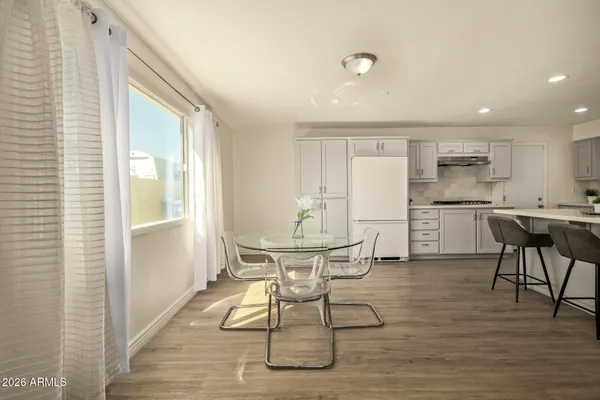 a view of a dining room with furniture and wooden floor