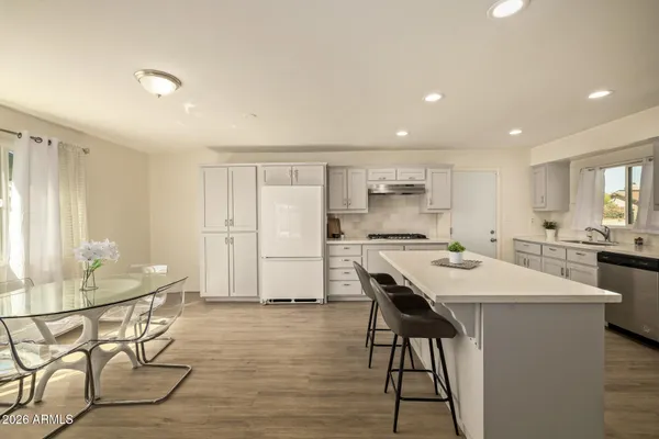 a kitchen with a table and chairs in it