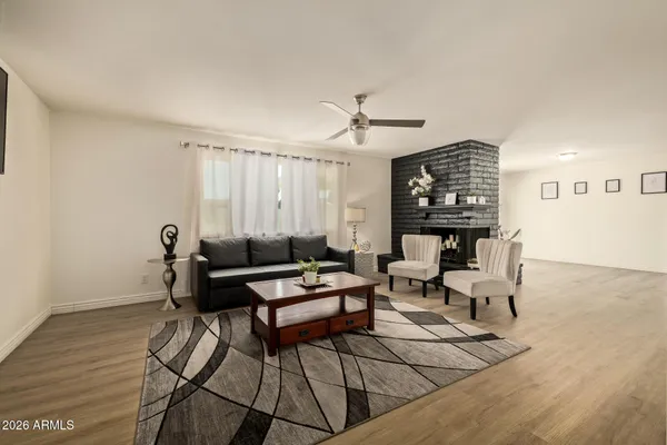 a living room with furniture a fireplace and a table