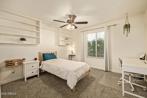 a bedroom with a bed and a window