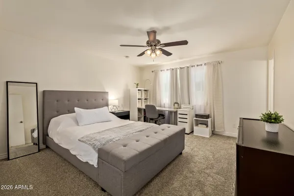 a bedroom with a bed and window
