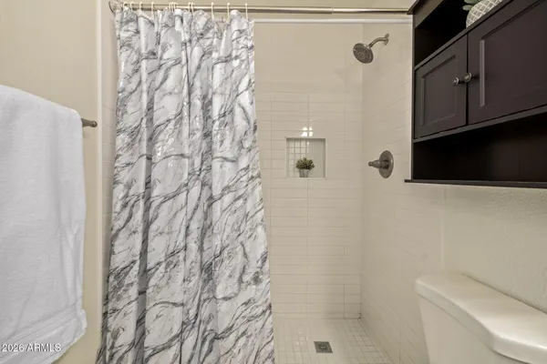 a bathroom with a shower curtain and a sink