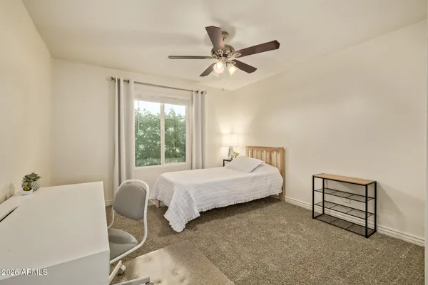 a spacious bedroom with a bed and a window