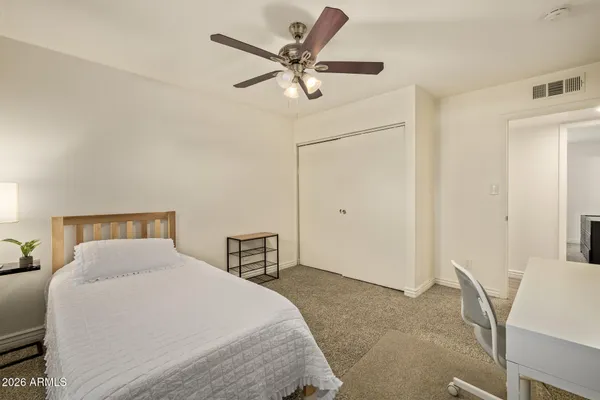 a bedroom with a bed and a table
