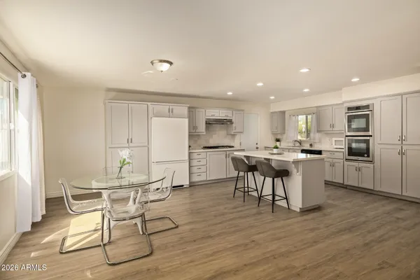 a kitchen with a table and chairs in it