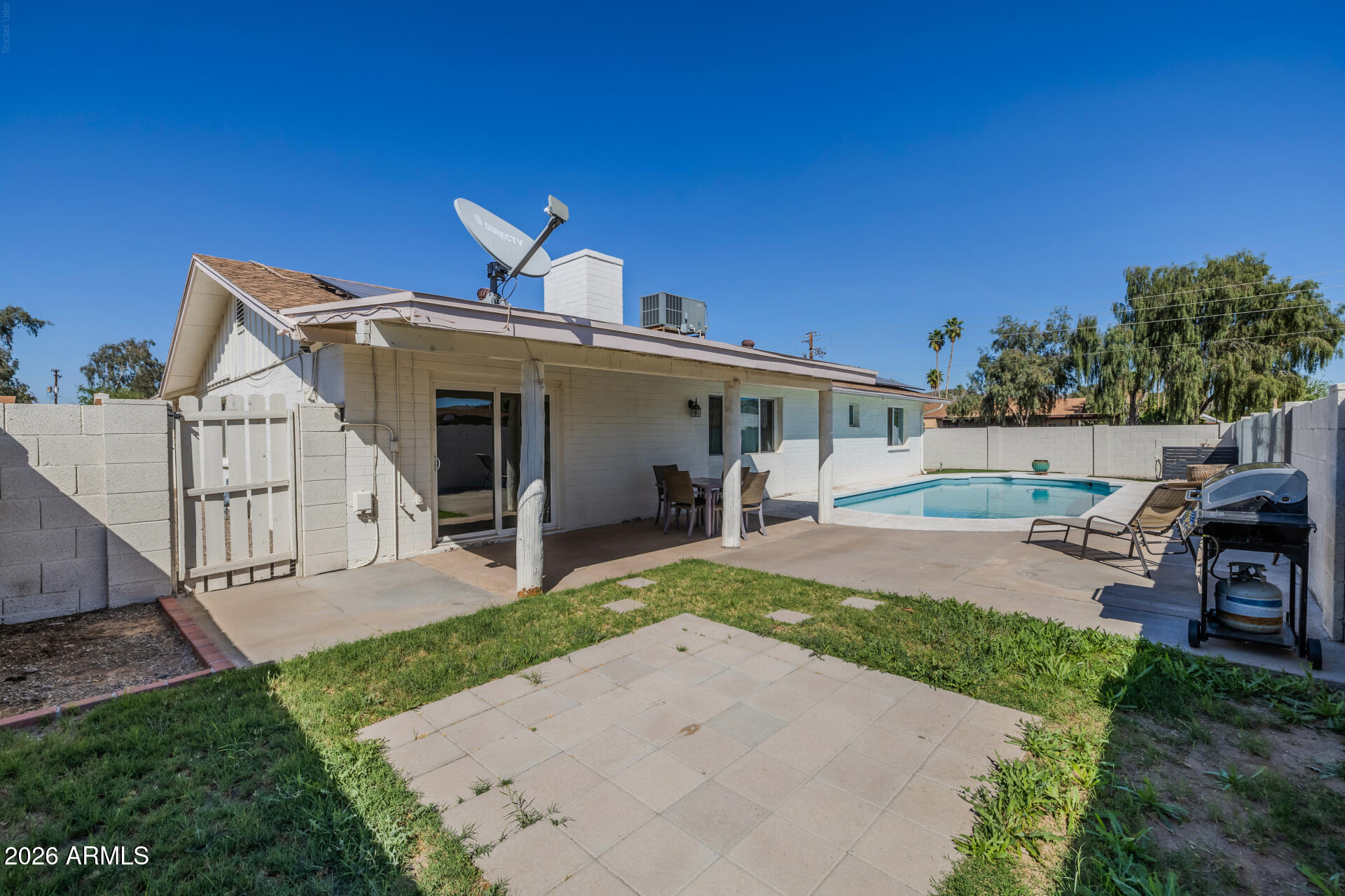3101 West Shangri-la Road Phoenix, AZ 85029 - Photo 33 of 37 a view of a house with a yard and table and chairs under an umbrella
