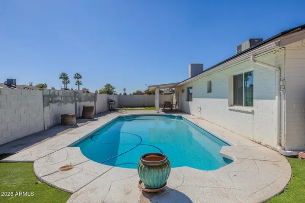 a view of a backyard with table and chairs