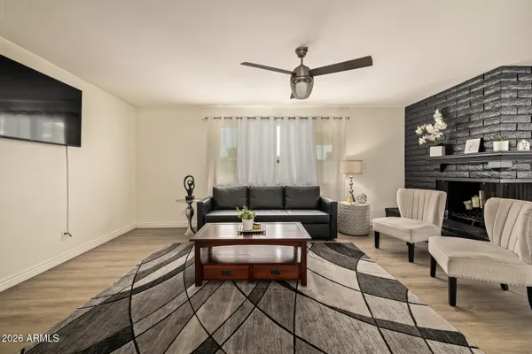 a living room with furniture a ceiling fan and a rug