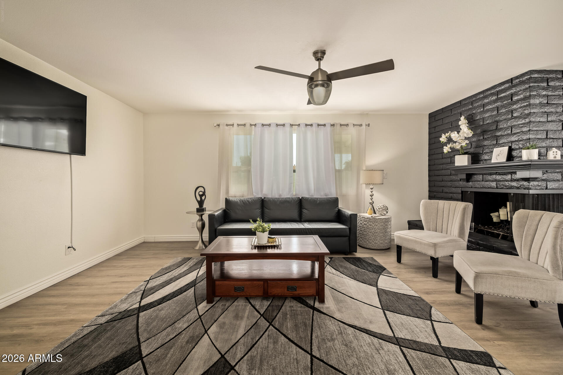 3101 West Shangri-la Road Phoenix, AZ 85029 - Photo 10 of 37 a living room with furniture a ceiling fan and a rug
