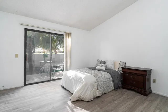 a bedroom with a bed and a view of kitchen