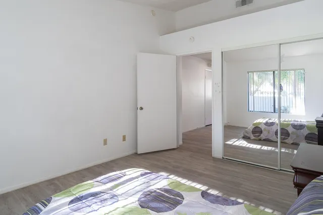 a bedroom with a bed and a lamp