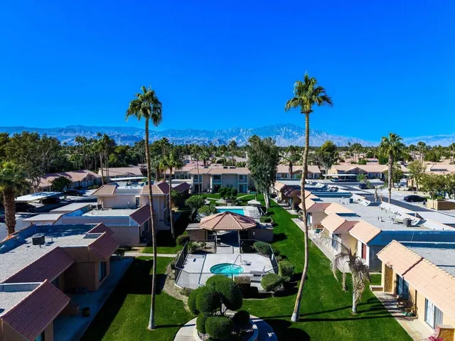 a view of a swimming pool and outdoor seating