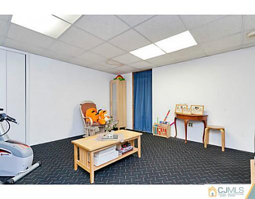 1406 Timber Oaks Road Edison, NJ 08820 - Photo 22 of 25 a living room with furniture and wooden floor