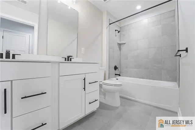 a bathroom with a toilet a sink and bathtub