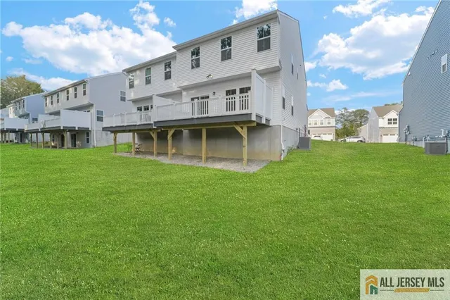 a view of a big house with a big yard and large trees