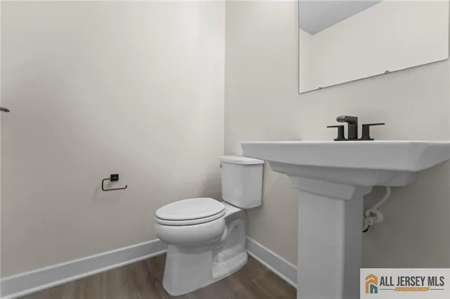 a bathroom with a sink toilet and a mirror