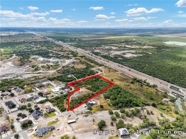a view of swimming pool with a table and chairs in patio