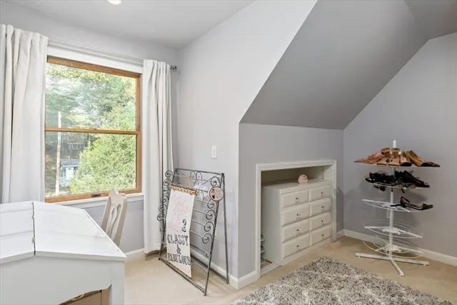 a bathroom with a granite countertop sink and a large mirror next to a window