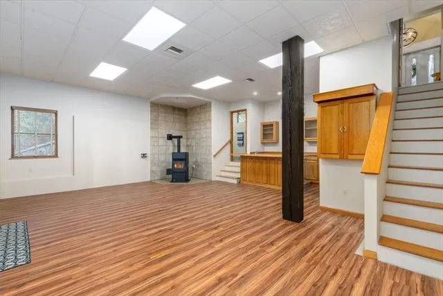 a view of a big house with a big yard and large trees