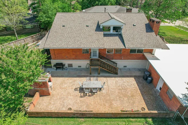 an aerial view of a house with garden space and seating