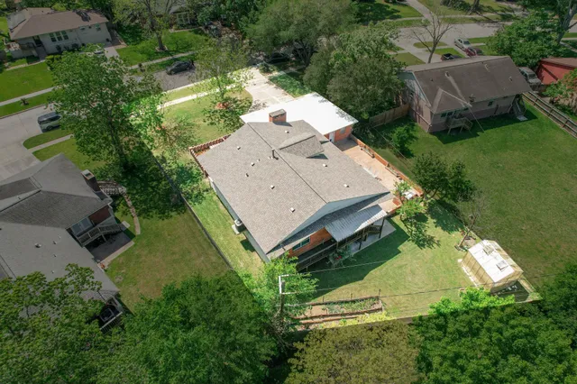 an aerial view of a house with a yard