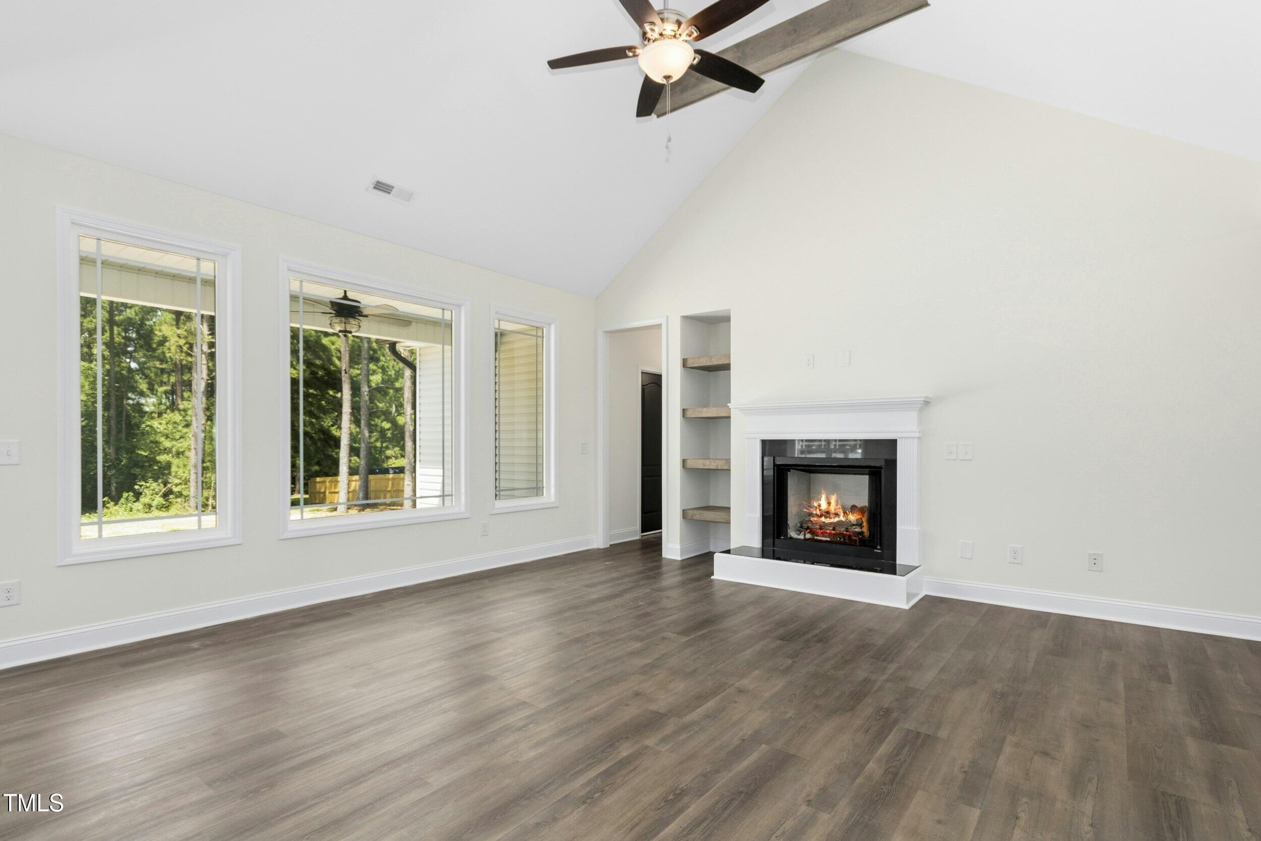776 Shadetree Road Benson, NC 27504 - Photo 13 of 35 an empty room with windows a fireplace