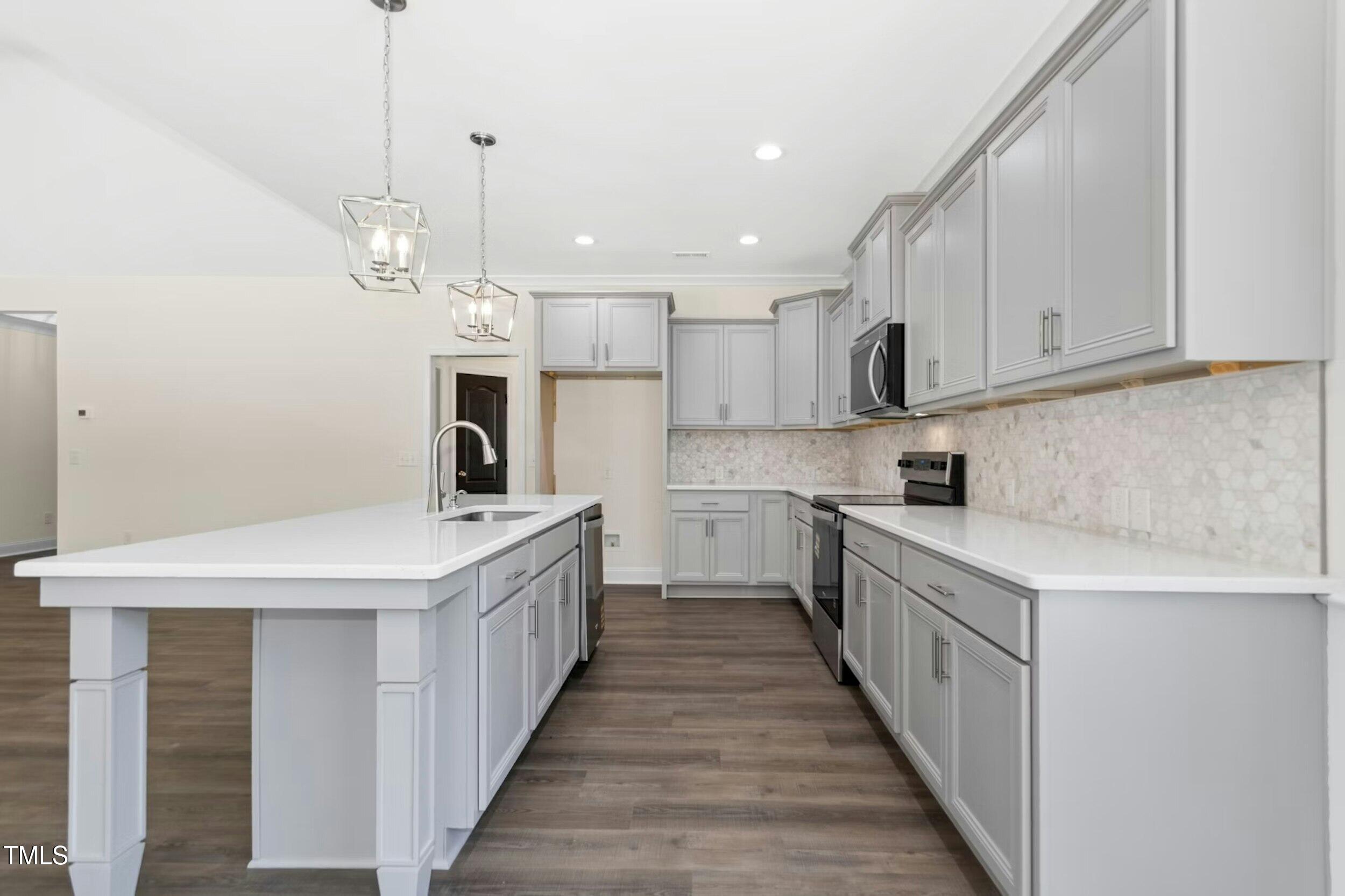 776 Shadetree Road Benson, NC 27504 - Photo 14 of 35 a kitchen with kitchen island granite countertop a sink a counter top space stainless steel appliances and cabinets