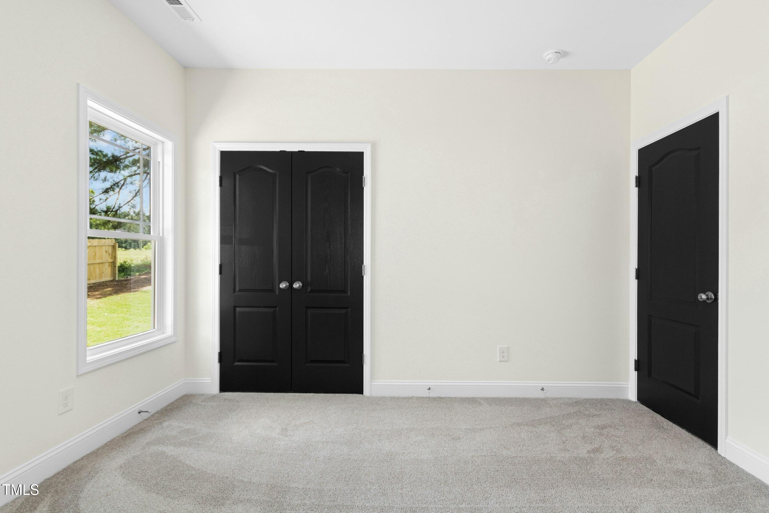 776 Shadetree Road Benson, NC 27504 - Photo 24 of 35 an empty room with windows and closet