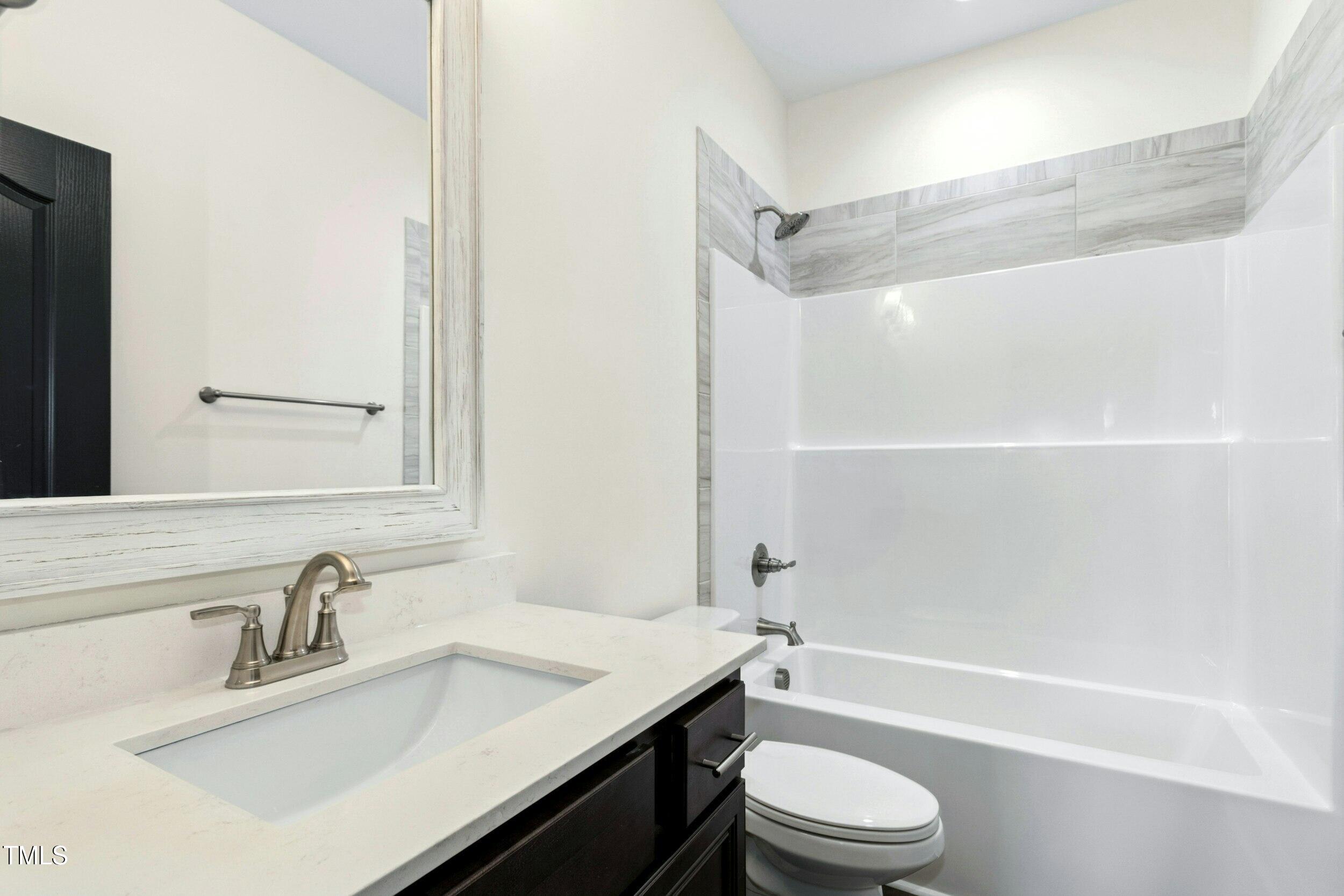 776 Shadetree Road Benson, NC 27504 - Photo 25 of 35 a bathroom with a sink a toilet and a bathtub