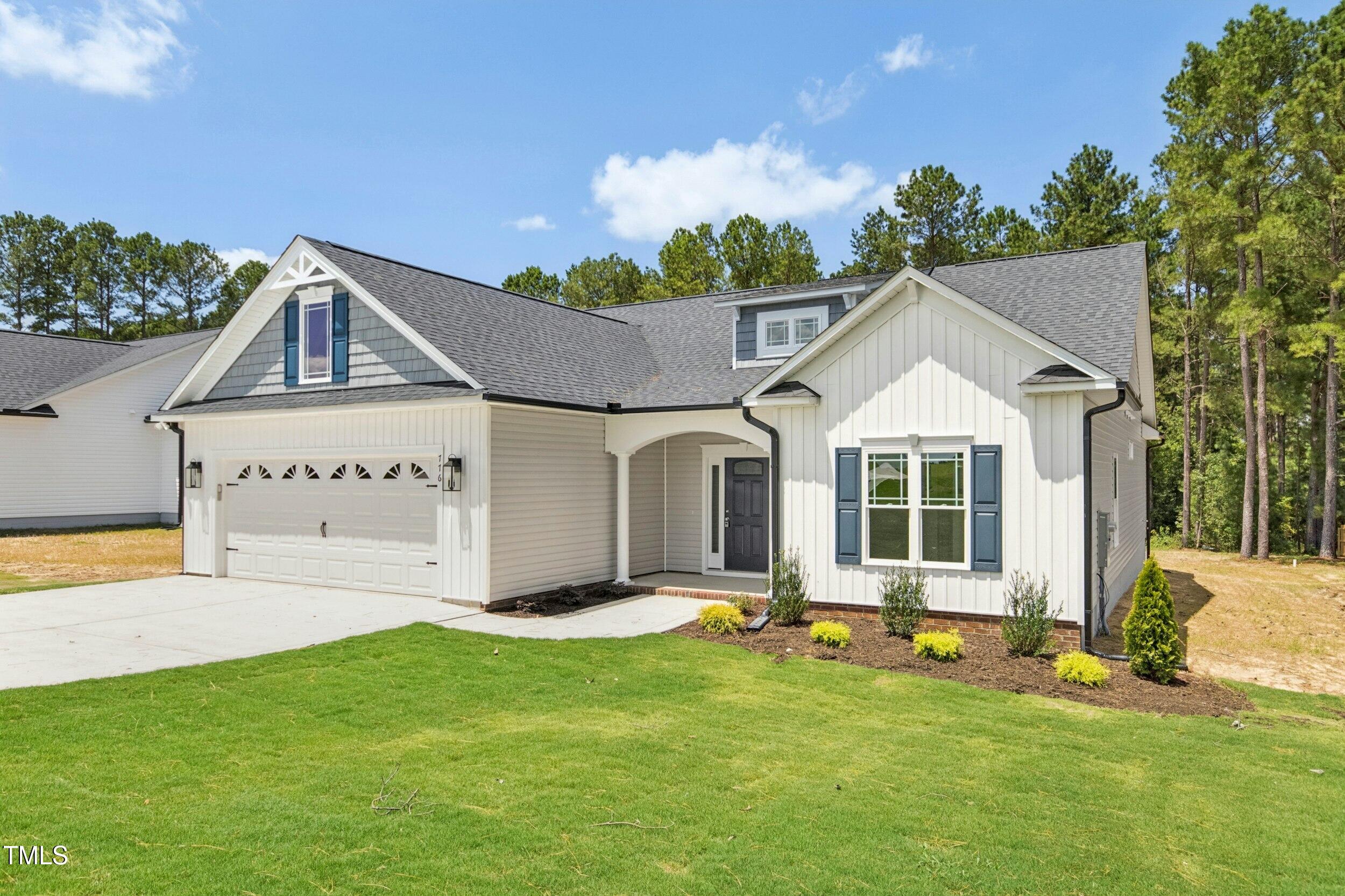 776 Shadetree Road Benson, NC 27504 - Photo 29 of 35 a front view of a house with a yard and garage