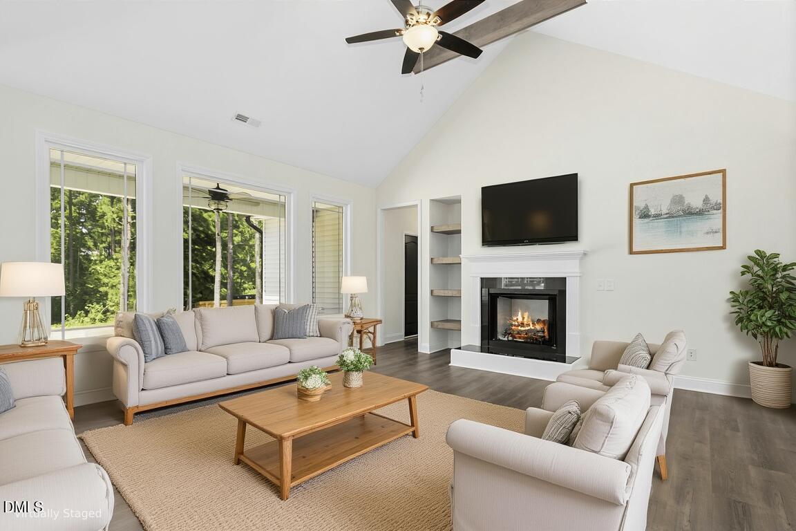 776 Shadetree Road Benson, NC 27504 - Photo 4 of 35 a living room with furniture a fireplace and a flat screen tv