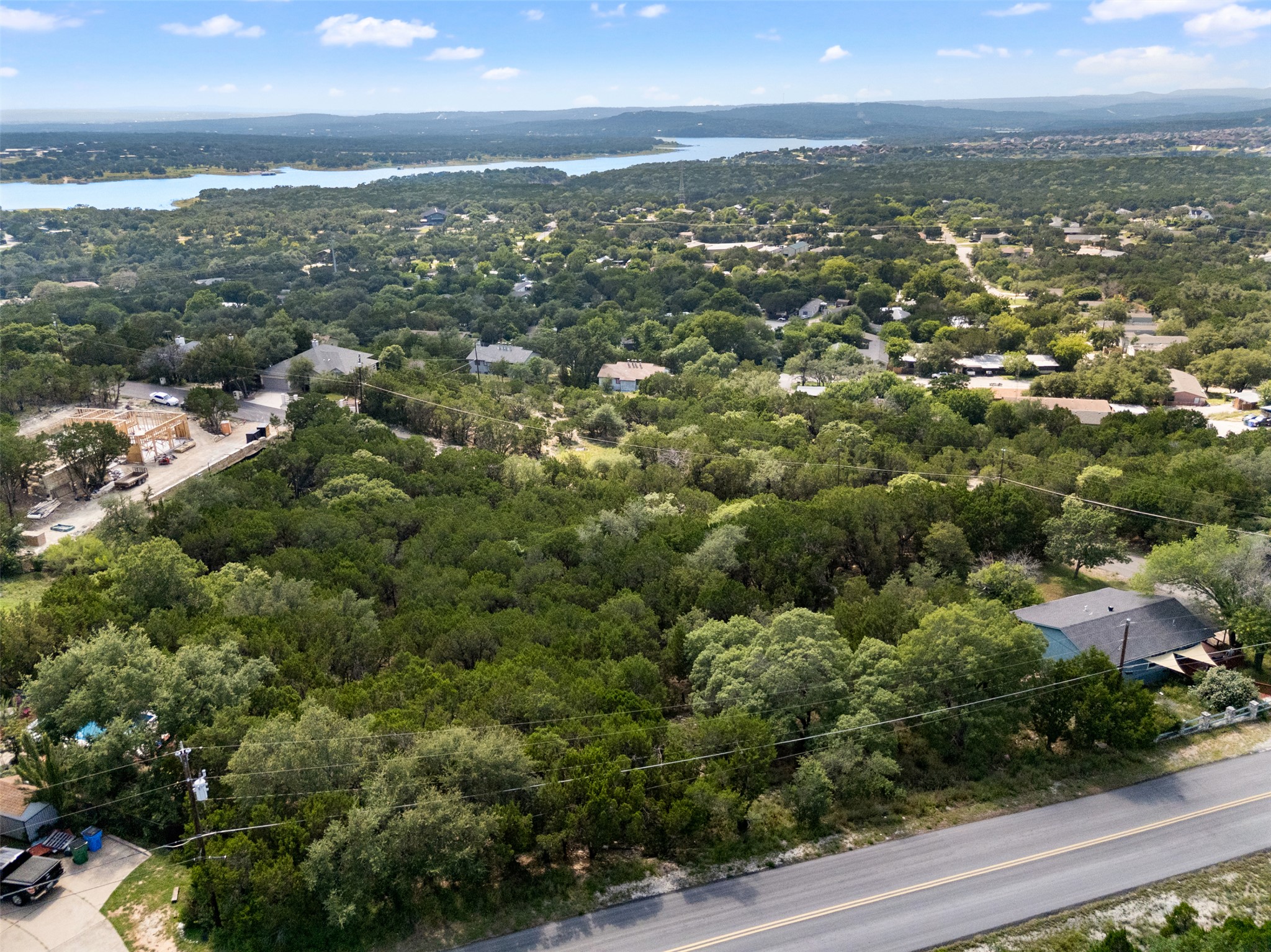 Perched above a verdant landscape, this expansive lot offers serene lake views and a peaceful, private setting.