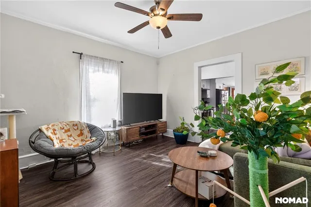a living room with furniture and wooden floor