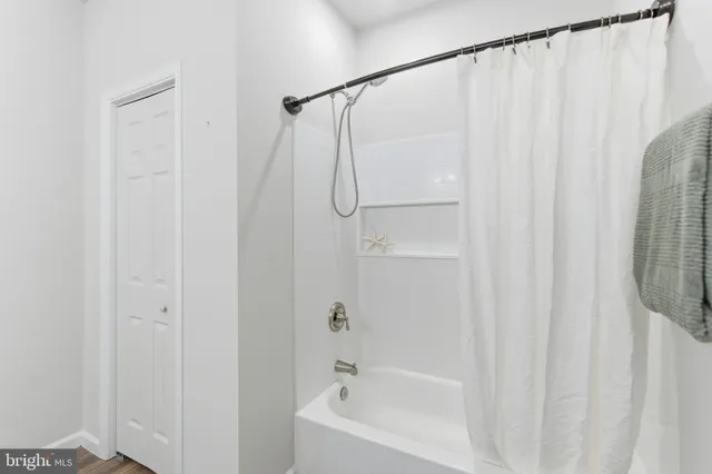 a bathroom with a shower curtain and a sink