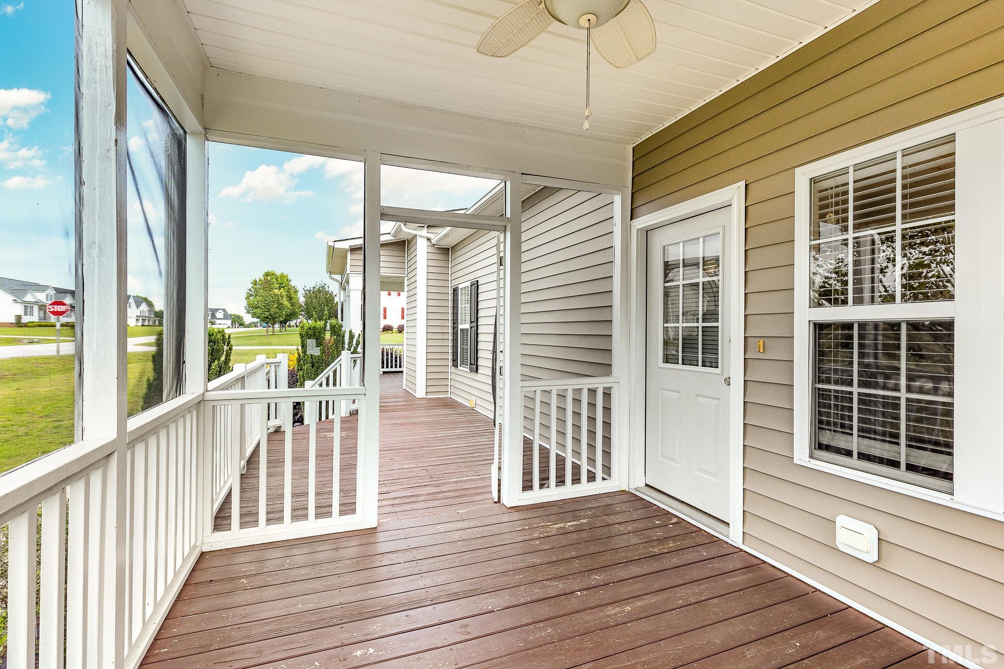 292 Ina Joe Place Willow Spring, NC 27592 - Photo 4 of 34 a view of a porch with wooden floor and floor to ceiling window
