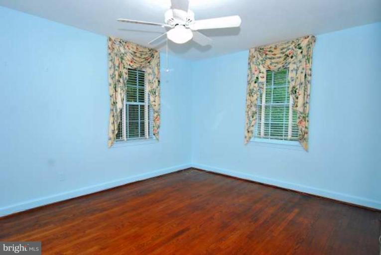 5308 Atlee Place Springfield, VA 22151 - Photo 11 of 14 an empty room with wooden floor chandelier fan and windows