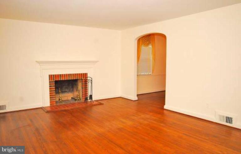 5308 Atlee Place Springfield, VA 22151 - Photo 5 of 14 a view of an empty room with wooden floor and a fireplace