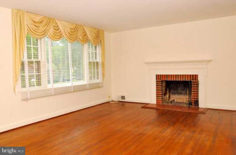 5308 Atlee Place Springfield, VA 22151 - Photo 6 of 14 a view of an empty room with a fireplace and a window