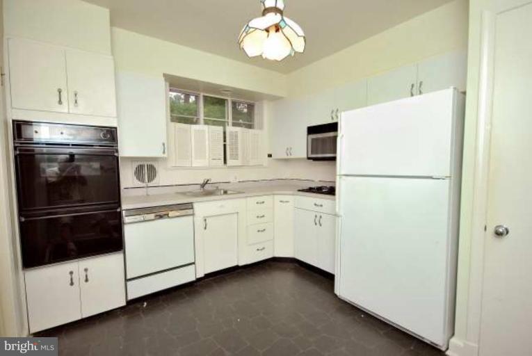 5308 Atlee Place Springfield, VA 22151 - Photo 8 of 14 a kitchen with cabinets appliances and a window