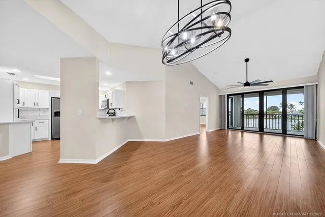 a view of a kitchen with wooden floor and cabinets